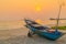 Sunset at anchor fishing boat at low tide