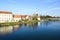 At sunset, the ancient buildings and reflections along the river in Ptuj with blue sky
