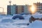 Sunset in the arctic city. Colorful panel buildings and a large tent in the snow.