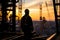 Sunset assessment Engineer man checks project at construction site silhouette