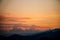 Sunset in the austrian alps with silhouette of colorful clouds and mountains in the austrian alps in styria