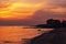 Sunset background on the beach. Soft wave hitting the shore