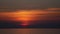 Sunset on the background of sea waves. Dramatic sky. Sky and orange-red clouds