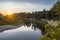 Sunset on a background of steep bend in the river with a sandy beach with a growing forest on it. River Western Bug in Europe - Po