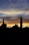 Sunset backlight of bell tower and houses roof