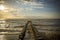 Sunset at the Baltic Sea with a groyne leading into the water