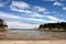 Sunset Bay State Park At Low Tide With Seagulls Under Blue Sky And Wisp Clouds