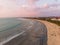 Sunset Beach in Bali, Indonesia. Badung City. Ocean Water and Tourists in Background. Popular Spot Among Tourists and Local People