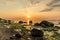 Sunset at the beach of the baltic sea with boulders in the forground