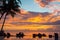 Sunset, beach chairs, palm trees, infinity swimming pool silhouette. Maldives