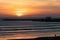 Sunset on the Beach in Essaouira Morocco near the Horizon with Waves and the Shipyard