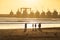 Sunset on the Beach in Essaouira Morocco with Silhouettes of People and Docked Boats