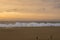 Sunset on beach near Espichel Cape with massive ocean waves in P