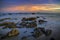 Sunset on the beach with rock islet