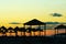 Sunset on the beach, the silhouettes of straw