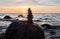 Sunset on the beach with a stack of stones in the foreground -Stone pyramids and glass sphere on the dreamy Baltic Sea