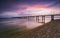 Sunset on the beach after a storm, the pier and the in the evening