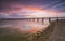 Sunset on the beach after a storm, the pier and the in the evening