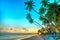 Sunset on the beach with tilted coconut trees,