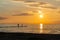 Sunset at the beach with two people as black silhouettes in the foreground