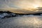 Sunset. Beautiful view of the northern snow covered shores of Scandinavia, Baltic sea at sunset