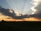 Sunset behind clouds over mountains