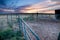 Sunset behind fencing and barn in Eastern Plains Colorado