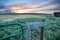 Sunset behind fencing and barn in Eastern Plains Colorado