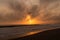 Sunset behind the Malibu Hills and the Pacific Ocean with Breaking waves