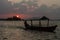 Sunset behind Santa Barbara islet with a boat crossing Peten Itza lake near Flores city, Guatema