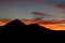 Sunset behind the volcano mountain silhouette