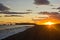 Sunset on black beach with Dyrholaey rock in background,Iceland