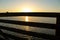 Sunset at bolsa chica wetlands through a wooden bridge