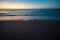 Sunset on calm beach slow shutter seascape