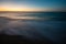 Sunset on calm beach slow shutter seascape