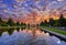 Sunset campus of Moscow university  under dramatic sky in spring with water reflections and swimming red ducks