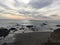 Sunset in Cayucos at the beach with rocks in the waves