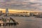 Sunset on the circular highway leading to the Rainbow Bridge with Cargo and cruise ships moored or sailing in Odaiba Bay of Tokyo