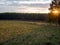 sunset on a clear day over a wooded ravine