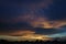 Sunset clouds and colored sky over town