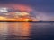 sunset cloudy sky night dark dramatic blue lilac gold orange sunset at sea water reflection boat on horizon in harbor nature la