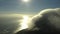 Sunset, cloudy sky with ocean and mountain from drone with nature, climate and remote travel location. Peak, sunrise and