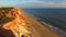 Sunset at coast cliffs beach aerial Portugal Algarve aerial view