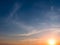 Sunset and colored cirrus clouds on a bright blue sky