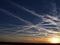 Sunset and contrails that turn into huge clouds