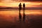 Sunset Couple. Silhouettes Of Young Man And Woman Staying Together At Beach. Vacation Or Honeymoon Concept.