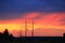 Sunset with crimson clouds and high-voltage line