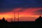 Sunset with crimson clouds and high-voltage line