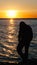 Sunset or dawn at sea. With man silhouette. Black Sea shore. Mobile Screensaver, Vertical Layout, Nature Wallpaper. Beautiful