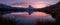 Sunset on dem Matterhorn and its reflection in a mountain lake